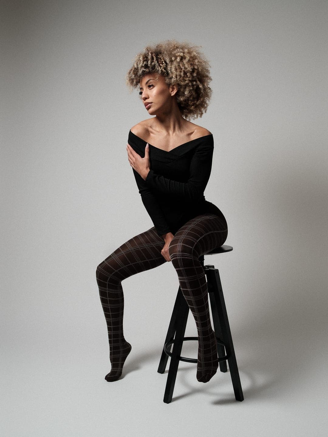 Tainá Ribeiro seated studio portrait — Brazilian model and dancer